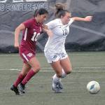 Pierces Regina Garay, left, and Peninsulas Grace Johnson chase a loose ball on Saturday in Port Angeles. (Keith Thorpe/Peninsula Daily News)