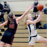Keith Thorpe/Peninsula Daily News Port Angeles Paige Mason, right, looks of the layup as Kingstons Ellee Brockman defends the lane on Thursday night at Port Angeles High School.