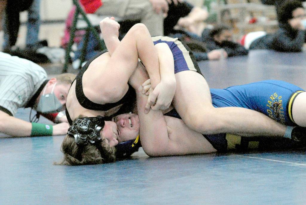Keith Thorpe/Peninsula Daily News Ari Skov of Sequim, top, takes on Fifes Cashious Koerth in the 170-lb. weight class at the Battle of the Axe on Saturday at Port Angeles High School.
