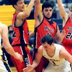 Forks' Riley Pursley (1) eyes the ball beneath the Wahkiakum defense from left Titan Niemela, Dominic Curl, and Tanner Collupy.  Looking on is Spartan Brody Lausche (22).  Photo by Lonnie Archibald.