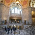 Washington State Patrol troopers stand near the state seal in the rotunda of the Legislative Building, Tuesday, Jan. 11, 2022, before Gov. Jay Inslee's scheduled State of the State address at the Capitol in Olympia, Wash. Due to cautions against COVID-19, Inslee will give the speech in the State Reception Room and it will be shown by streaming video to lawmakers meeting remotely. (AP Photo/Ted S. Warren)