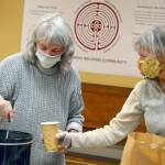 Marny Friedman, left, and Christine Emmes are part of the Just Soup crew each Tuesday at St. Pauls Episcopal Church, where free hot lunches are handed out in the church parking lot. (Diane Urbani de la Paz/Peninsula Daily News)