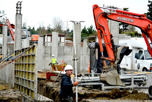 Jaymon Skinner of Bernt Ericsen Excavating is part of the crew moving earth for the foundation of 7th Haven, the Olympic Community Action Programs housing project at Seventh and Hendricks streets in Port Townsend. (Diane Urbani de la Paz/Peninsula Daily News)