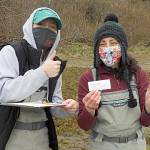 Representatives with the Makah Fisheries Management, Angelina Woods, left, and Adrianne Akmajian, hold up the first European green crab captured last year in April. The Makah Tribe would go on to catch more than 1,400 green crab, their most ever. (Photo courtesy Adrianne Akmajian/ Makah Fisheries Management)