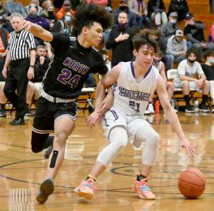 Sequim's Jaydin Possin (21) dribbles against the defense of North Kitsap's Jalen East on Thursday in Sequim. (Michael Dashiell/Olympic Peninsula News Group)