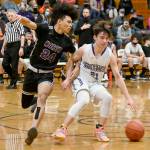Sequims Jaydin Possin (21) dribbles against the defense of North Kitsaps Jalen East on Thursday in Sequim. (Michael Dashiell/Olympic Peninsula News Group)