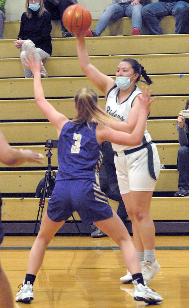 Keith Thorpe/Peninsula Daily News Port Angeles Angelina Sprague, right, makes a high pass over the head of North Kitsaps Evelyn Beers on Thursday at Port Angeles High School.