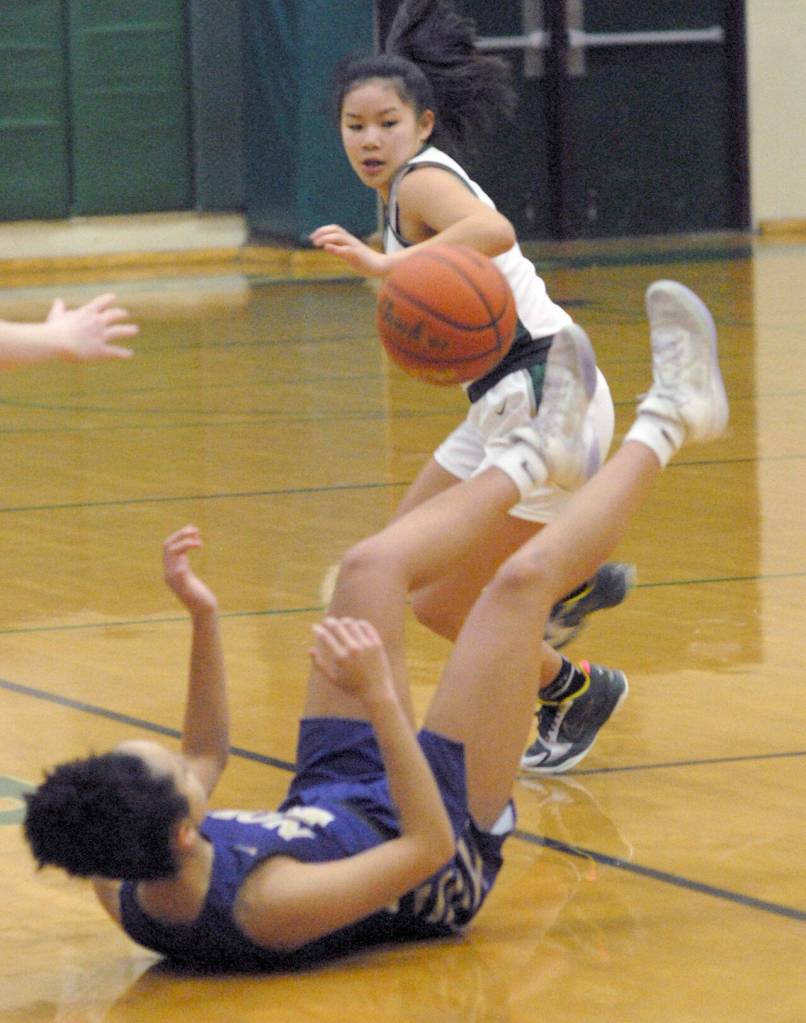 Keith Thorpe/Peninsula Daily News Port Angeles Jenna McGoff looks back on the ball as North Kitsaps Ayanna Selembo takes a tumble on Thursday at Port Angeles High School.