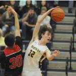 Forks' Ryan Rancourt (32 ) out-jumps Raymond's Morgan Anderson (30) to start the overtime portion of Saturday night's league game played in Forks. Forks won 67-66. (Lonnie Archibald/for Peninsula Daily News)