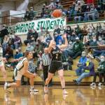 Jesse Major/For Peninsula Daily News Port Angeles Eve Burke, left, and Sequims Hannah Bates eye a loose ball during the Roughriders 60-36 Senior Night win over the Wolves.