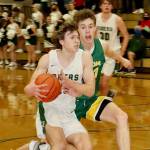 Port Angeles' Parker Nickerson drives against Sehome's Grant Kepley on Friday night in Port Angeles. Nickerson scored 11 points in the third quarter to help spark a Roughriders comeback win. (Dave Logan/for Peninsula Daily News)