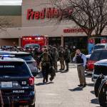 Authorities stage outside a Fred Meyer grocery store after a fatal shooting at the business on Wellsian Way in Richland, Wash., Monday, Feb. 7, 2022. (Jennifer King/The News Tribune via AP)