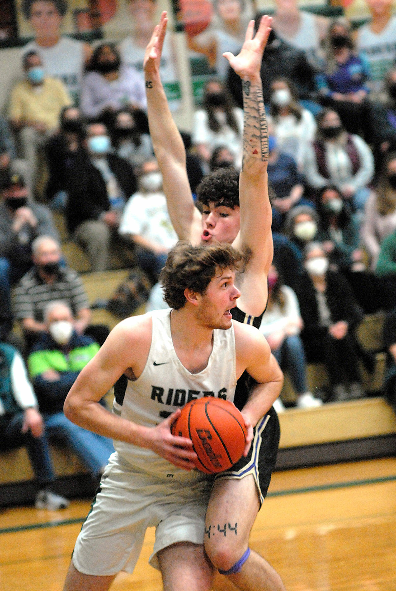 Keith Thorpe/Peninsula Daily News Port Angeles Wyatt Dunning, front, tries to evade the defense of North Kitsaps Jonas La Tour during Thursday nights game at Port Angeles High School.