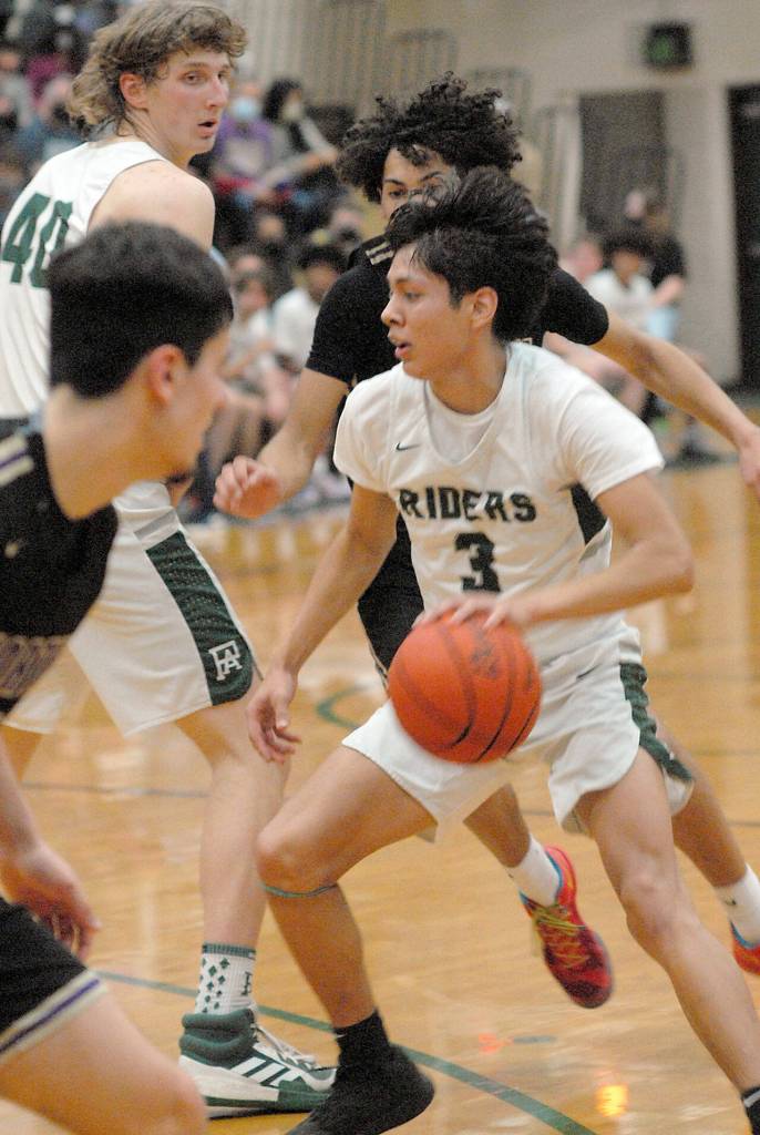 Keith Thorpe/Peninsula Daily News Port Angeles Quanah Wheeler, front right, slips past North Kitsaps Harry Davies, right, and Johny OIlmsted, left, as Wheelers teammate, John Vaara, looks on during Thursdays match-up at Port Angeles High School.