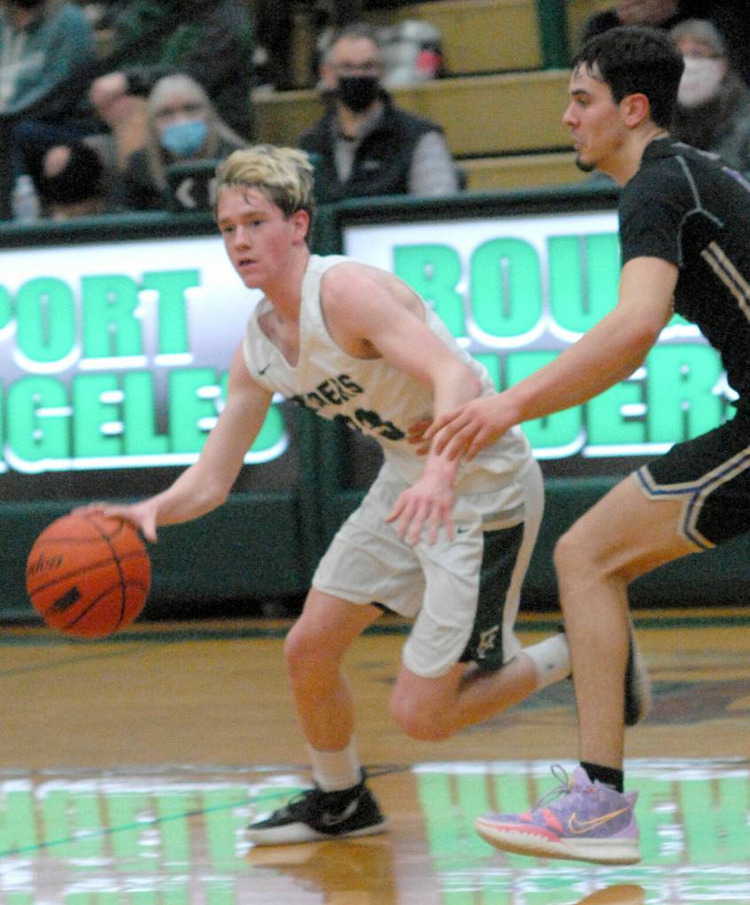 Keith Thorpe/Peninsula Daily News Port Angeles Michael Soule, left, slips past North Kitsaps Johny Olmsted on Thursday in Port Angeles.