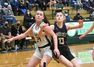 Port Angeles' Lexie Smith, left and Sequim's Lauryn Stephens battle for rebounding positions. (Michael Dashiell/Olympic Peninsula News Group)