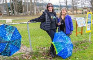 Emily Matthiessen / Olympic Peninsula News Group
Brigitte Schlemmer and Suzanne Horne hang the first pieces for Art All Over  The Art Show Without Walls, this past weekend at Carrie Blake City Park.