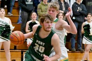 Port Angeles' Wyatt Dunning drives around the defense of Lynden's Kobe Baar in the 2A regionals held Friday night in Mount Vernon. (Michael Dashiell/Olympic Peninsula News Group)