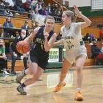 Sequims Addie Smith drives around Lyndens Mallary Villars in the state 2A regional game held Friday night in Mount Vernon. (Michael Dashiell/Olympic Peninsula News Group)
