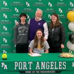 Port Angeles' Zoe Smithson, seated, recently signed a letter of intent to play softball at Pacific Lutheran University in Parkland. Smithson is joined by, from left by her brother Ian, dad Larry and mom Staci at her signing ceremony.