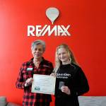 Matthew Nash/Olympic Peninsula News Group
Liz Parks, president of RE/MAX Prime, presents fifth grader Kendall Adolphe with a certificate and gift card for winning the Sequim Irrigation Festivals button design contest.