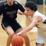 Keith Thorpe/Peninsula Daily News Port Angeles Xander Maestas, front, drives past North Kitsaps Johny Olmsted on Thursday night in Port Angeles.