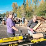 Staci Poythress and Pam Cunningham split logs to raise funds for a graduation party for the Port Angeles High School Class of 2022.
