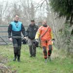 Clallam County Sheriffs deputies Dylan Heck, left, and Hector Eagan, right, accompanied by Sgt. John Keegan, prepare to search for evidence on Friday in a section of nearby Siebert Creek in the Feb. 24 double homicide east of Port Angeles. (Keith Thorpe/Peninsula Daily News)