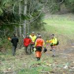 Clallam County Search and Rescue members and sheriffs deputies prepare to search in the woods near Wild Current Way on Friday for possible evidence in a Feb. 24 double homicide east of Port Angeles. (Keith Thorpe/Peninsula Daily News)