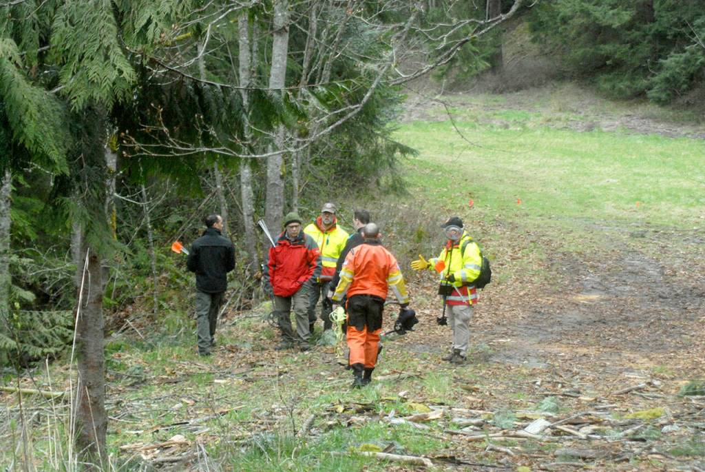 Clallam County Search and Rescue members and sheriffs deputies prepare to search in the woods near Wild Current Way on Friday for possible evidence in a Feb. 24 double homicide east of Port Angeles. (Keith Thorpe/Peninsula Daily News)