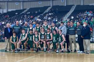 Port Angeles poses with the Class 2A Boys Basketball Tournament's sixth-place trophy at the Yakima Valley SunDome on Saturday. The Roughriders finished 20-8 on the season, won a share of the Olympic League title and earned their first trophy at state since 1997.