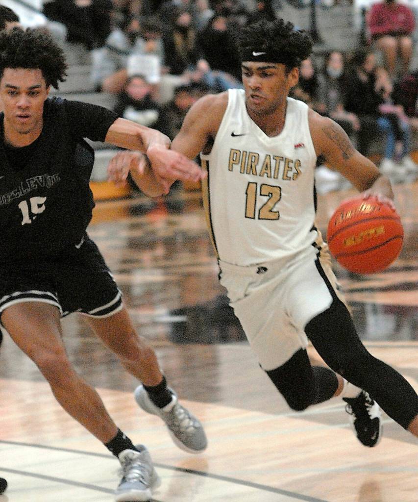 Peninsulas Roosevelt Williams Jr., right, tries to push past Bellevues Nate Johnson on Saturday evening on the Pirate home court. (Keith Thorpe/Peninsula Daily News)