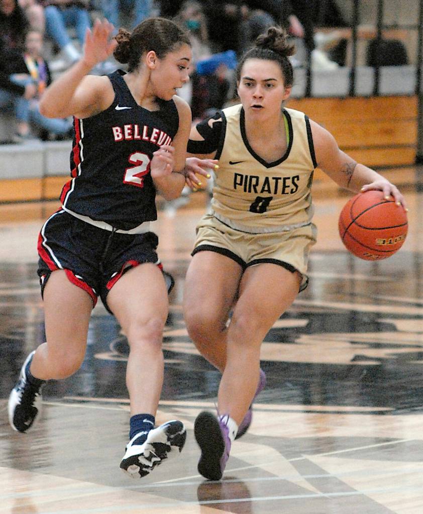 Peninsulas Keeli-Jade Smith, right, drives past Bellevues Alashae Bell on Saturday in Port Angeles. (Keith Thorpe/Peninsula Daily News)