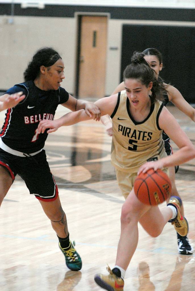 Peninsulas Hope Glasser, right, looks for a way around the defense of Bellevues Evelyn Ioane on Saturday at Peninsula College in Port Angeles. (Keith Thorpe/Peninsula Daily News)