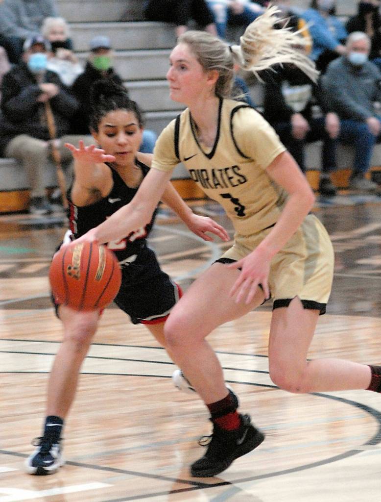 Peninsulas Millie Long, right, heads for the lane as Bellevues Brianna Byrnes tries to defend on Saturday in Port Angeles. (Keith Thorpe/Peninsula Daily News)