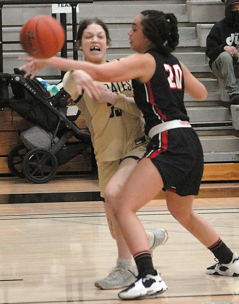 Peninsulas Madison Cooke passes around Bellevue defender Helen Van Ess on Saturday at Peninsula College. (Keith Thorpe/Peninsula Daily News)