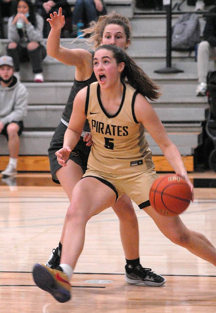 Peninsulas Hope Glasser heads for the lane past Shorelines Gracie Browning on Wednesday at Peninsula College. (Keith Thorpe/Peninsula Daily News)
