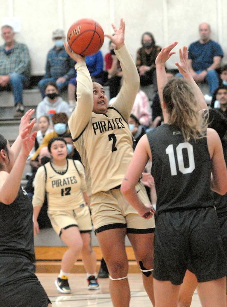Peninsulas Tatianna Kamae, center, takes aim at the net on Wednesday against Shorline during Wednesdays regular season finale. (Keith Thorpe/Peninsula Daily News)