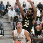 Peninsulas Jaylin Reed, front, looks for the hoops as Shorelines Morgan Brown defends the lane on Wednesday at Peninsula College in Port Angeles. (Keith Thorpe/Peninsula Daily News)