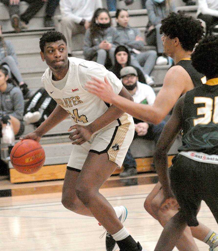 Peninsulas Isaiah Sampson, left, evades the defense of Shorelines Deshawn McFerrin and Tim Opany, right, on Wednesday night in Port Angeles. (Keith Thorpe/Peninsula Daily News)