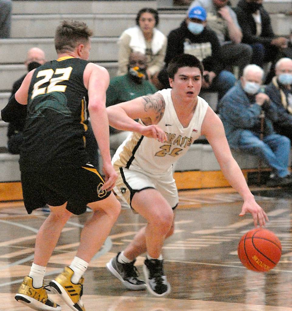 Peninsulas Isaac Garcia, right, slips past Shorelines David Perkins on Wednesday in Port Angeles. (Keith Thorpe/Peninsula Daily News)
