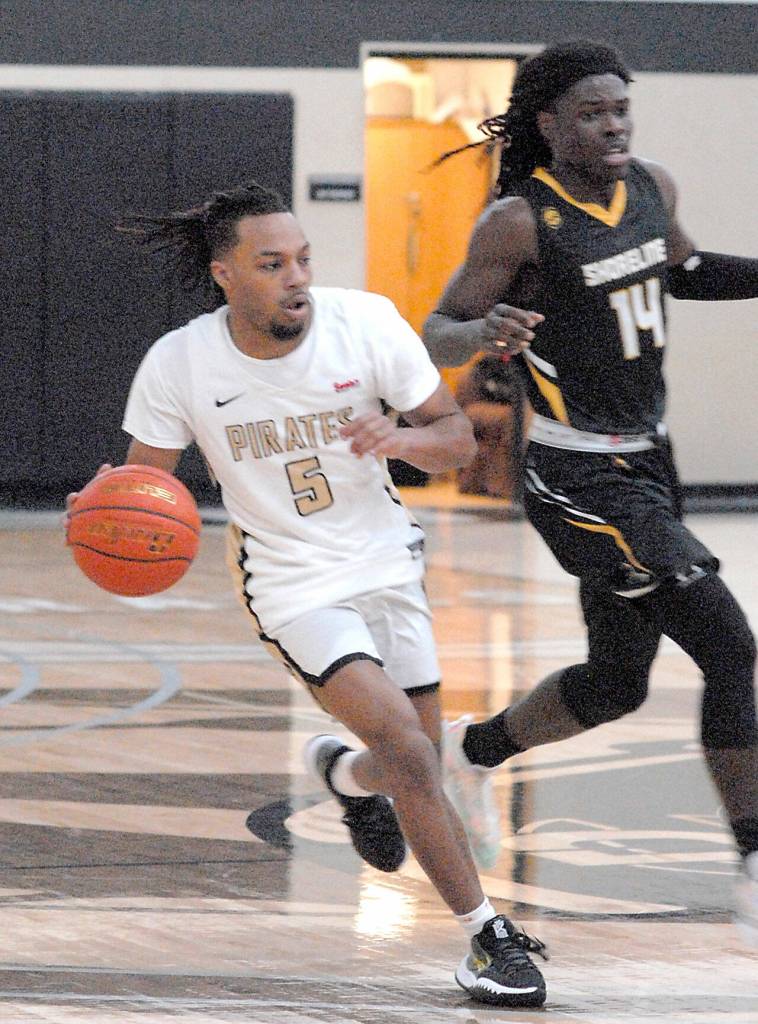 Keith Thorpe/Peninsula Daily News
Peninsula's Rayshawn Harris, left, outraces Shoreline's A.J. Boyd during Wednesday's game at Peninsula College.