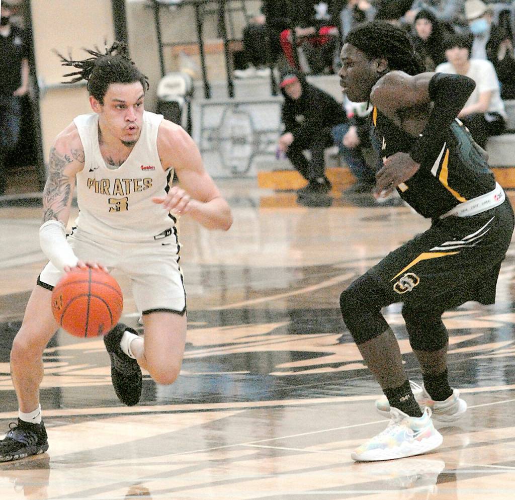 Peninsulas Jaylin Reed, left, is defended by Shorelines A.J. Boyd on Wednesday at Peninsula College. (Keith Thorpe/Peninsula Daily News)