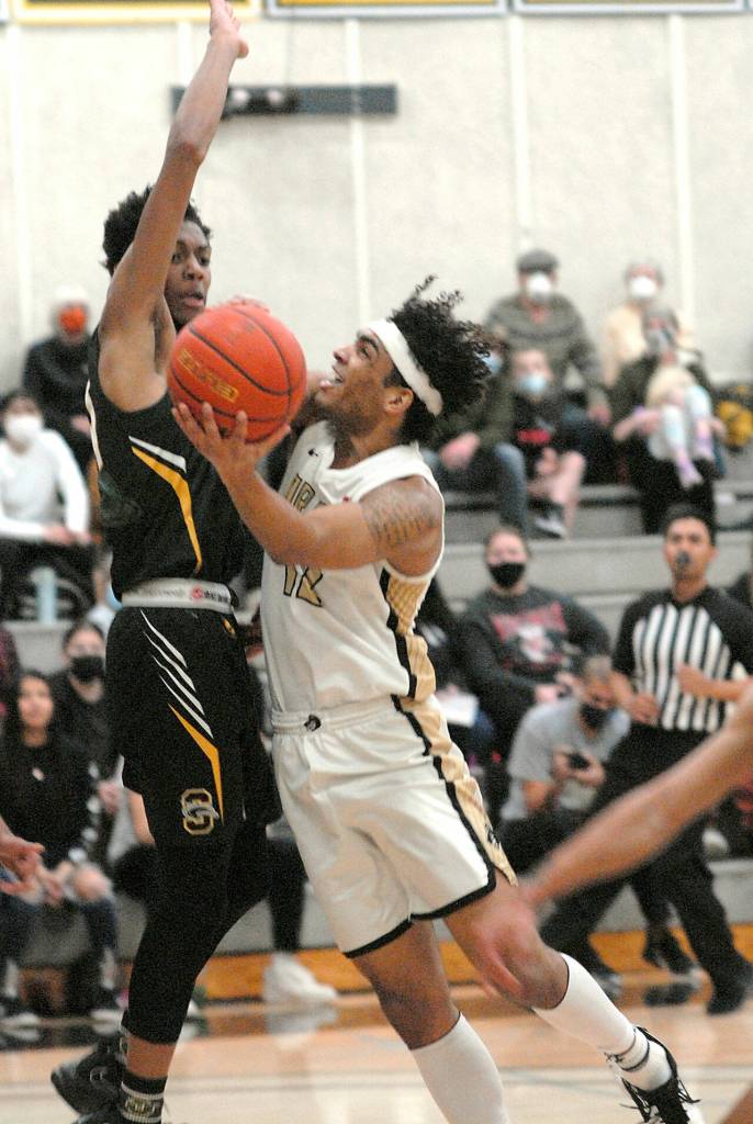 Peninsulas Roosevelt Williams Jr., right, takes aim at the net while defended by Shorelines Jalyn Stepney on Wednesday at Peninsula College. (Keith Thorpe/Peninsula Daily News)