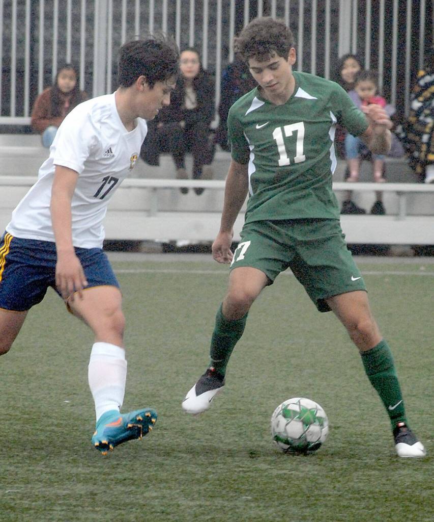 Keith Thorpe/Peninsula Daily New Forks Jesus Ayala, left, challenges Port Angeles Dayton Williams for the ball on Saturday at Peninsula College in Port Angeles.