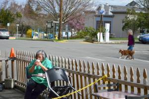 Kelly Toy of Port Townsend sips a beverage Tuesday afternoon at the Seal Dog Coffee-Uptown Pub streatery on Lawrence Street. The Port Townsend City Council is considering making the pandemic-spurred streatery program permanent. (Diane Urbani de la Paz/Peninsula Daily News)