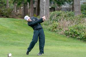 Steve Mullensky/for Peninsula Daily News
Sequim’s Dom Riccobene drives the ball with an iron on the second hole at Port Ludlow Golf Course during a match Thursday against the North Kitsap Vikings.