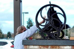 Pastor Joey Olsen blesses the 19th-century bell at Trinity United Methodist Church in February. (Courtesy photo)