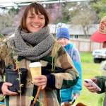 Plant and Seed Exchange Organizer Ashley Kehl, left in hat, mingles with visitors including Bryan DeCaterina of Port Townsend, at right, and Daryl Dietrich of Quilcene on Sunday at Shy Acre Farm during the annual event in Port Townsend. Held on the first day of spring, there was a chilly breeze and a good turnout. (Diane Urbani de la Paz/Peninsula Daily News)