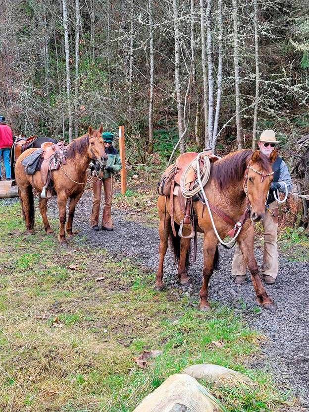 Back Country Horsemen members Tim and Paula Keohane traveled from Whidbey Island to join the Peninsula Chapters ride through Dungeness Trails. Even through spring has sprung most horses, such as these two, have yet to shed their long and warm winter coats thus they tend to sweat more easily even when walking on a trail. (Courtesy photo by Linda Morin / Back Country Horsemen Peninsula Chapter)